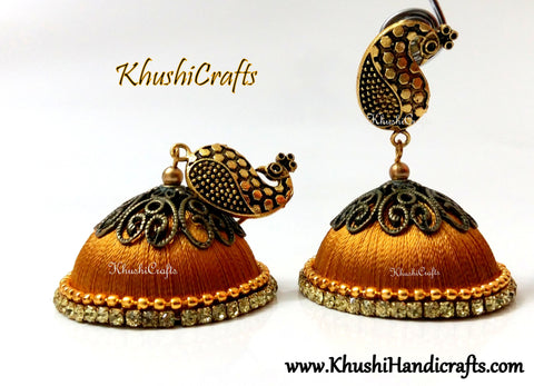 Gold Designer Extra large Silk Jhumkas enhanced with a Peacock Stud