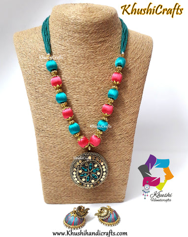 Peach and Teel silk thread Necklace set with Tibetan pendant and silk jhumkas!