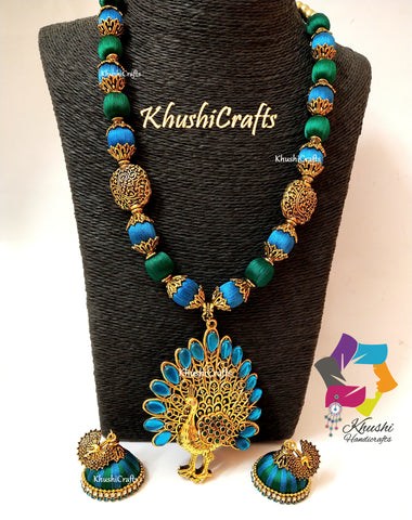 Silk thead Necklace Set in Peacock shades with Peacock Pendant and a pair of handmade Jhumkas